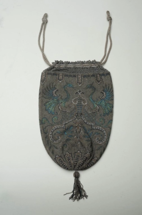 Knitted, beaded, drawstring handbag with rampant peacock design.