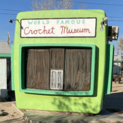 A green building with the words World Famous Crochet Museum