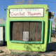 A green building with the words World Famous Crochet Museum