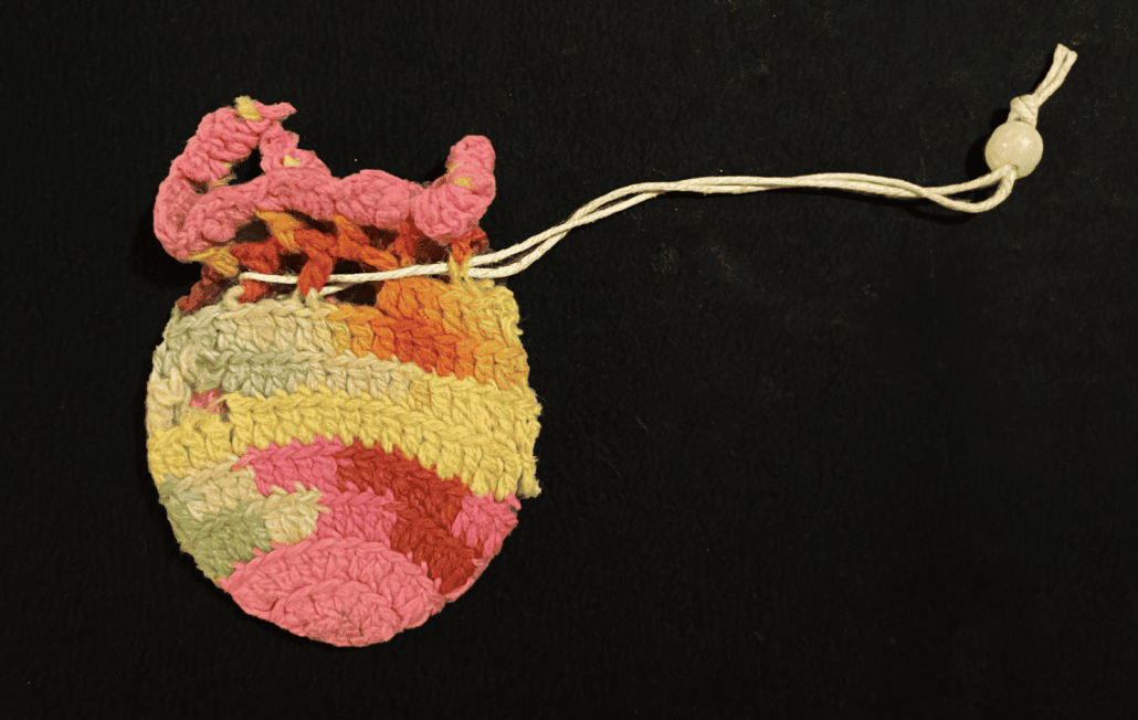 A multicolored crochet pouch