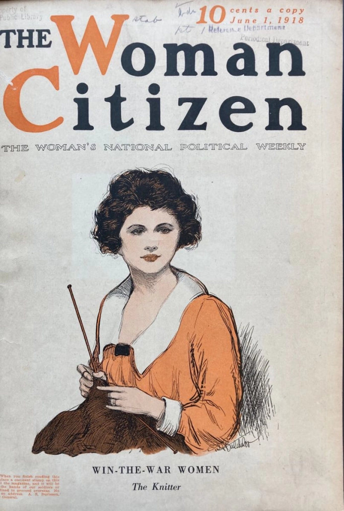 The cover of "The Woman Citizen" magazine with a woman wearing a red blouse and holding knitting needles and khaki colored knitting, likely a sweater