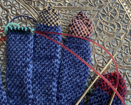 Rainbow Fingertips for Sanquhar Gloves on Antique Brass Table.