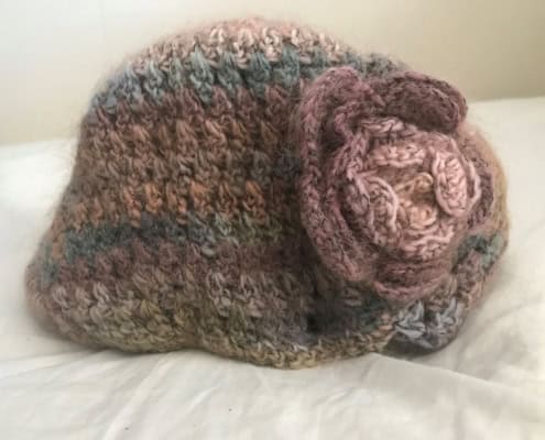 Knit cap with a knit rose accent